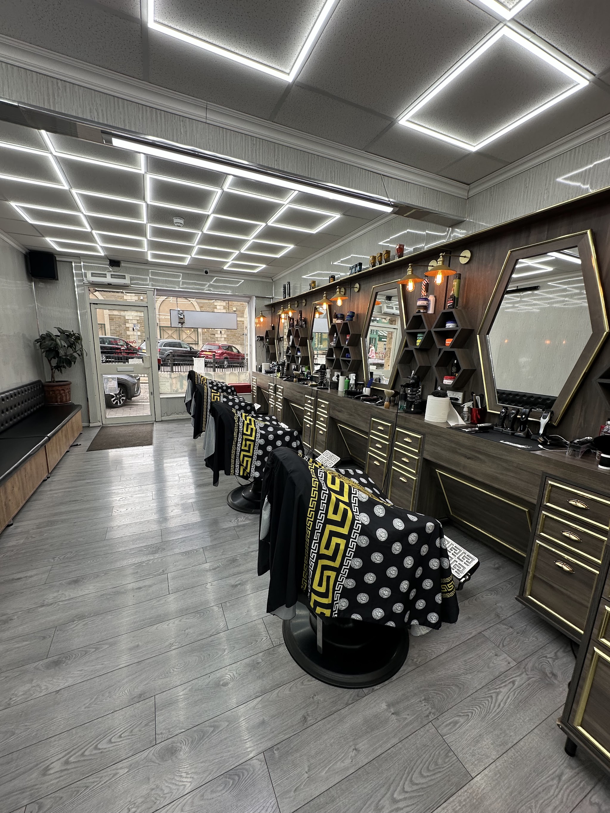 The barber chairs and mirrors looking towards Yeadon Barber's High Street entrance